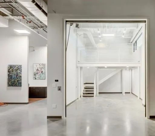 a view of an empty room with a fireplace and a window