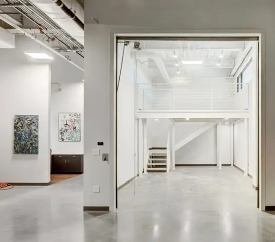 a view of an empty room with a fireplace and a window