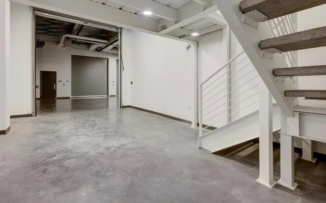 a view of a room with stairs and a ceiling fan
