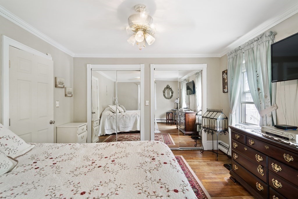 259 Kingsley Road Hull, MA 02045 - Photo 11 of 20 a bedroom with a bed and a flat screen tv