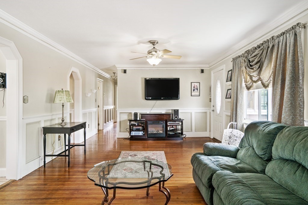 259 Kingsley Road Hull, MA 02045 - Photo 8 of 20 a living room with furniture a fireplace and a flat screen tv