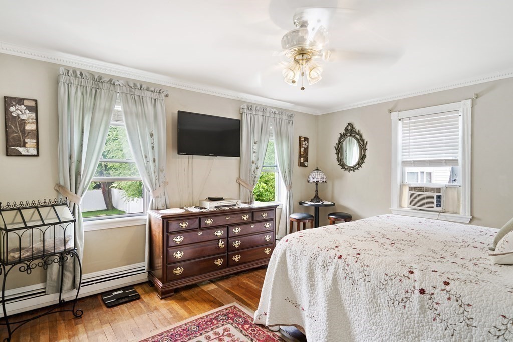 259 Kingsley Road Hull, MA 02045 - Photo 10 of 20 a bedroom with a bed and a flat screen tv