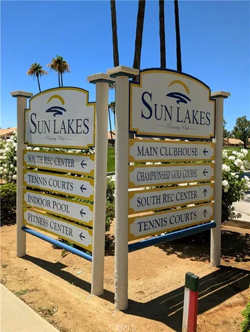 a street sign on a wall next to a road