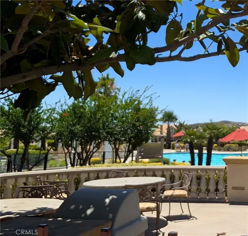 a view of swimming pool with outdoor seating