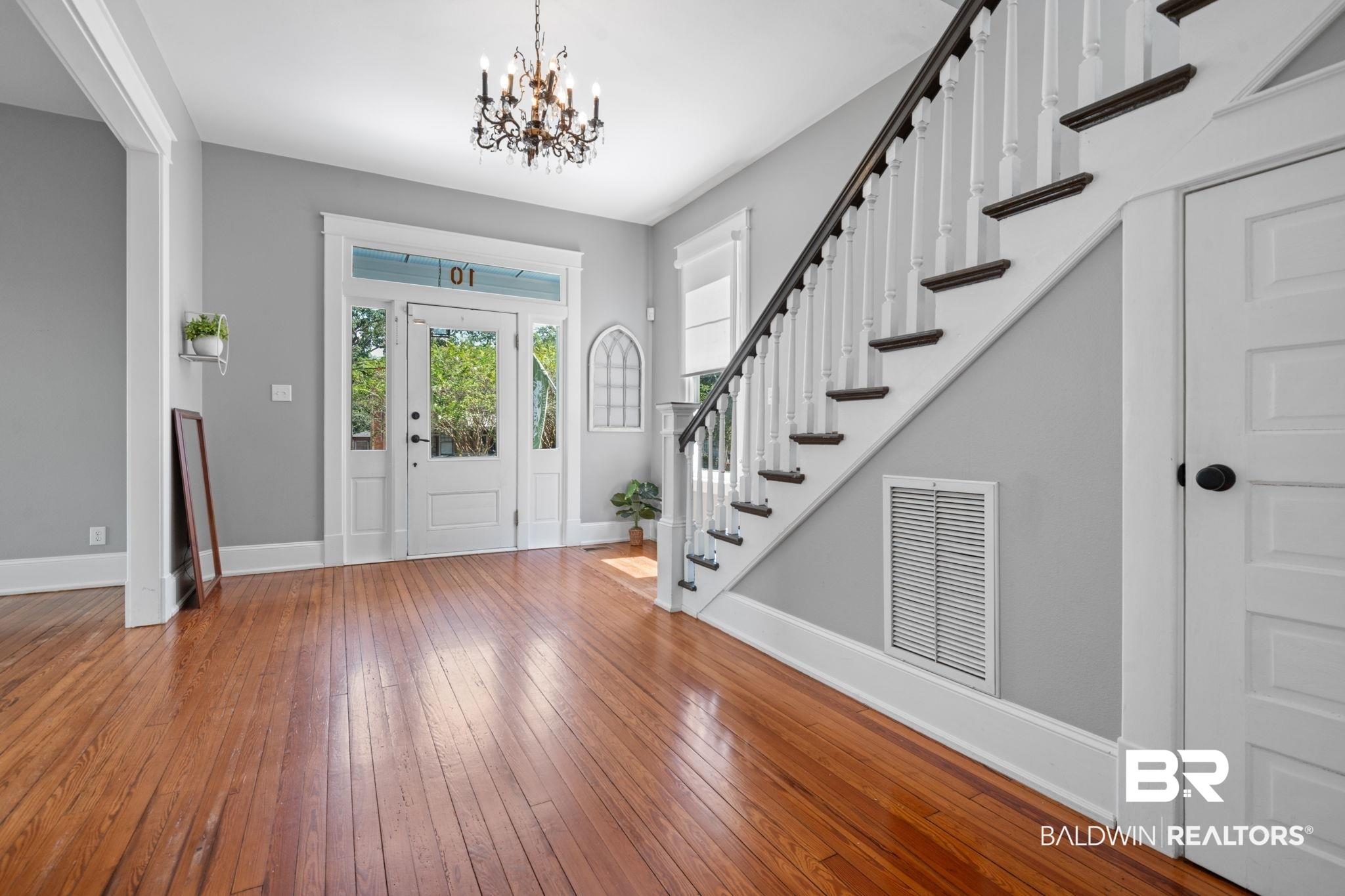 10 South Monterey Street Mobile, AL 36604 - Photo 7 of 45 Foyer with hardwood / wood-style floors, stairs, and a chandelier