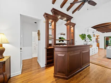 a bedroom with a bed and a chair with the bookshelf