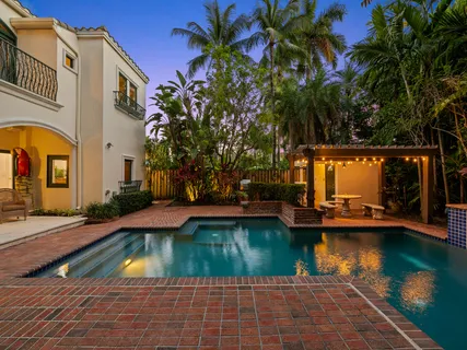 a kitchen with stainless steel appliances granite countertop a refrigerator and a wooden cabinets