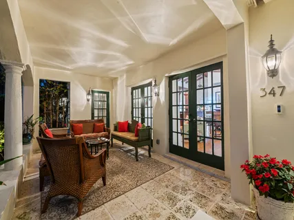 a view of a patio with a table and chairs and potted plants