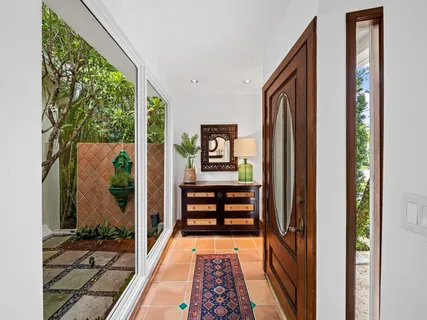 a view of a dining room with furniture and a chandelier