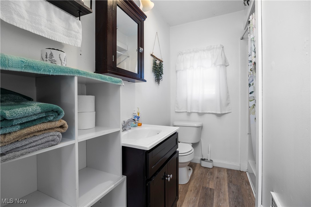 340 Erie Road Vermilion, OH 44089 - Photo 18 of 34 Full bathroom with vanity, toilet, independent shower and bath, and hardwood / wood-style flooring