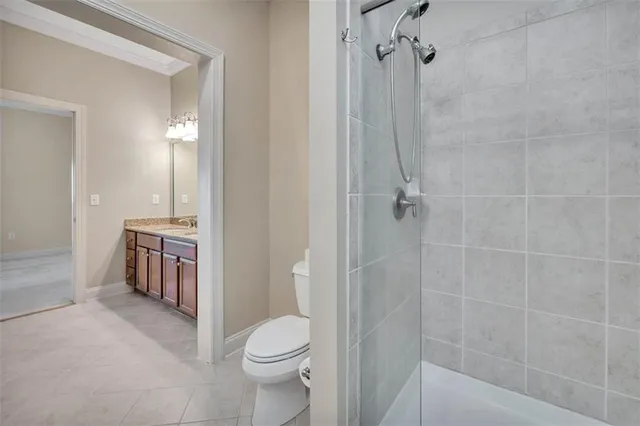 a bathroom with a toilet a sink a vanity and shower