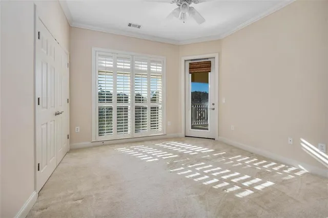a view of a livingroom with a ceiling fan and window