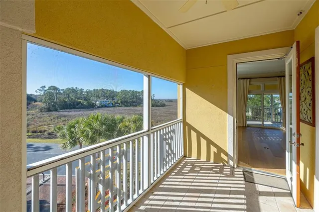 a view of a balcony with wooden floor and fence