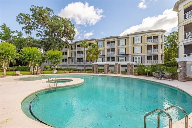 a swimming pool with outdoor seating and yard