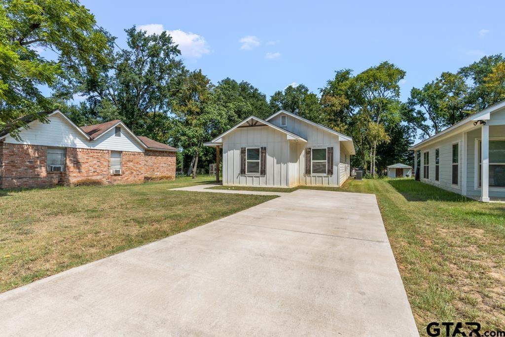 1919 West Jackson Street Tyler, TX 75701 - Photo 2 of 35 a front view of a house with a yard and garage