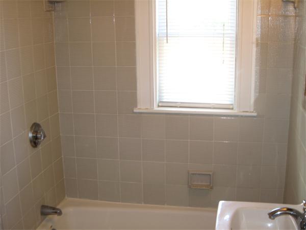 181 Rindge Avenue Cambridge, MA 02140 - Photo 5 of 5 a bath tub sitting next to a white sink and a shower