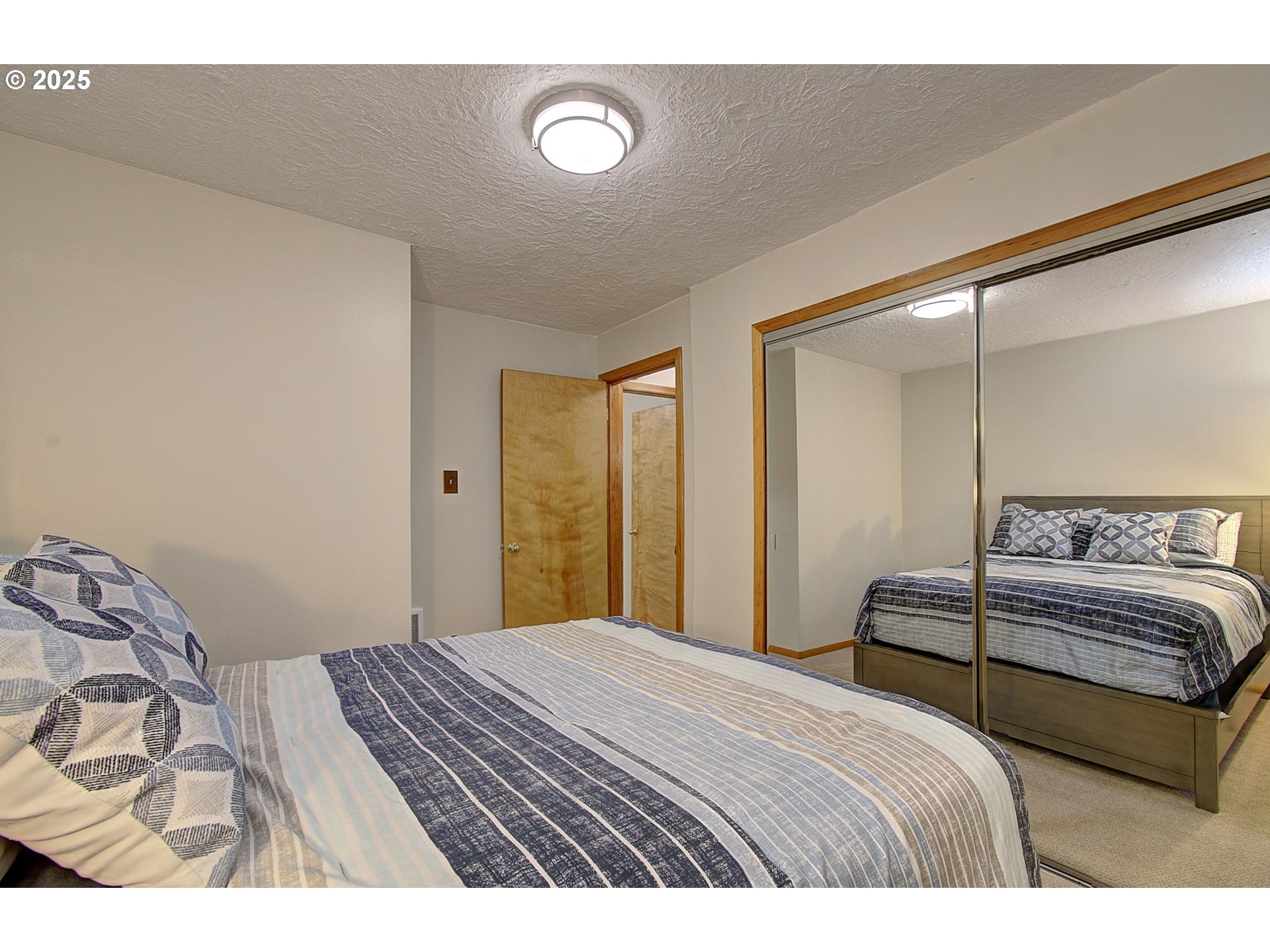 5911 Alki Road Vancouver, WA 98663 - Photo 14 of 29 a bedroom with a bed and a lamp