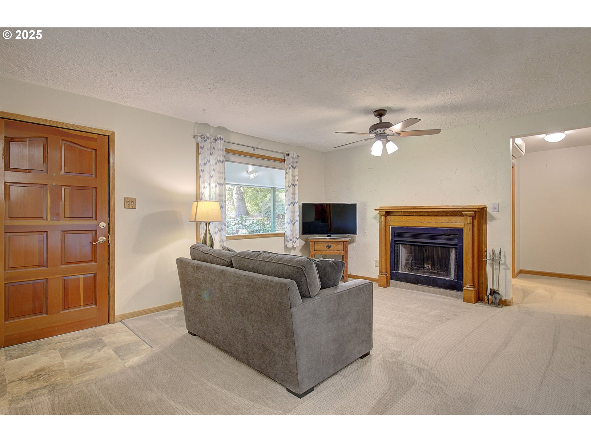 5911 Alki Road Vancouver, WA 98663 - Photo 6 of 29 a living room with furniture and a fireplace