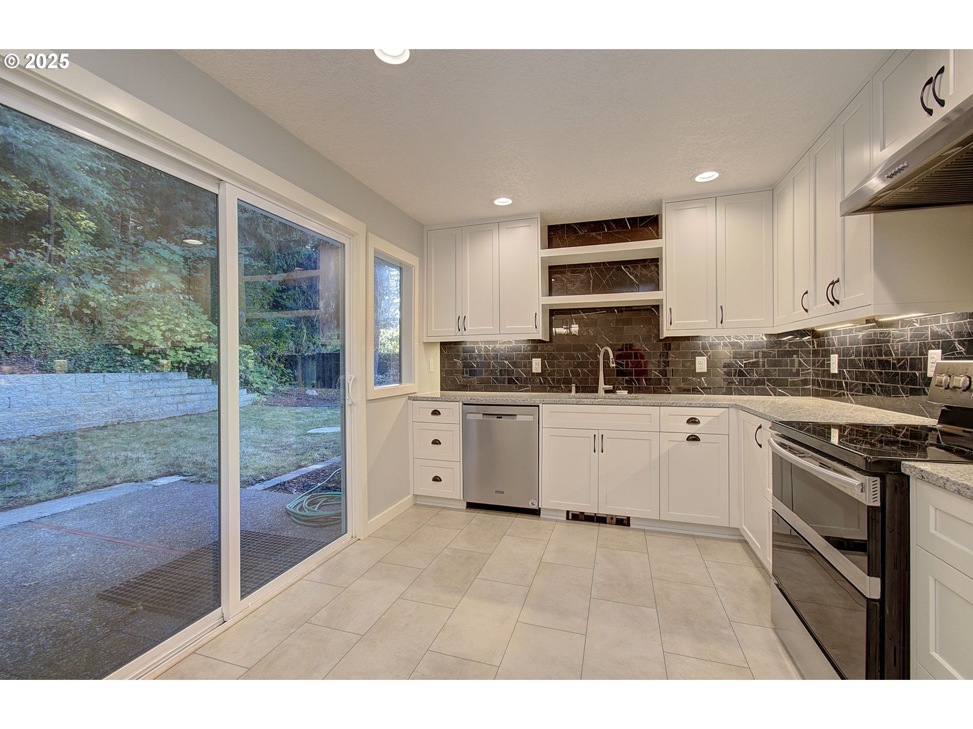 5911 Alki Road Vancouver, WA 98663 - Photo 10 of 29 a kitchen with stainless steel appliances granite countertop a stove a sink and a refrigerator
