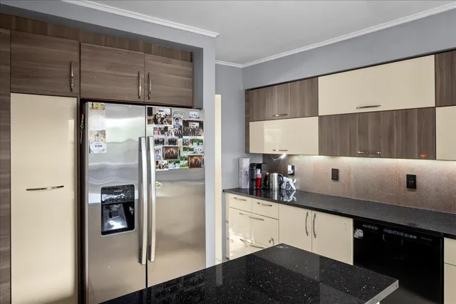 a kitchen with a refrigerator and cabinets