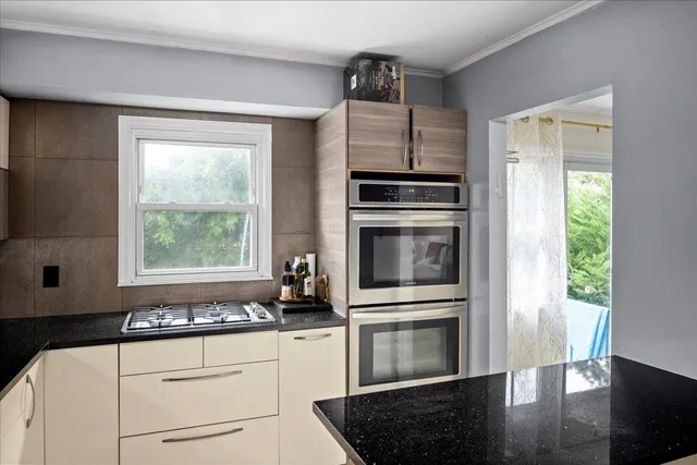 a kitchen with granite countertop a stove and a refrigerator
