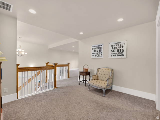 557 Craftsman Way Midway, UT 84049 - Photo 32 of 59 Carpeted landing featuring a two-tone wood and white banister, recessed ceiling lighting, and crown molding