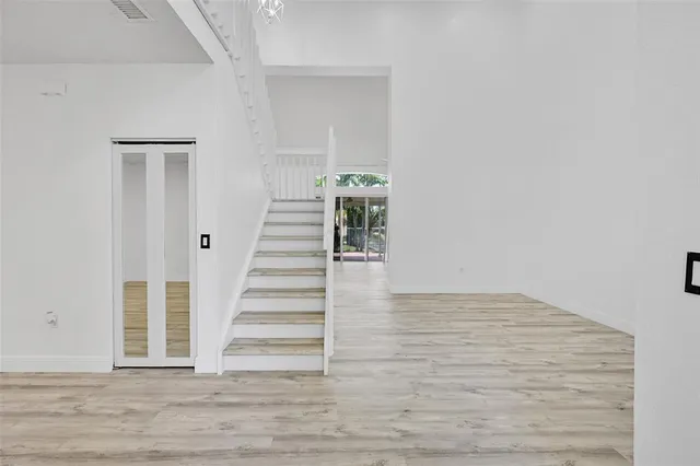 a view of a hallway with wooden floor and entryway