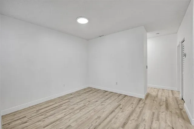 a view of room with wooden floor