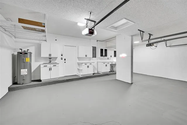 a view of a kitchen with refrigerator cabinets and a sink