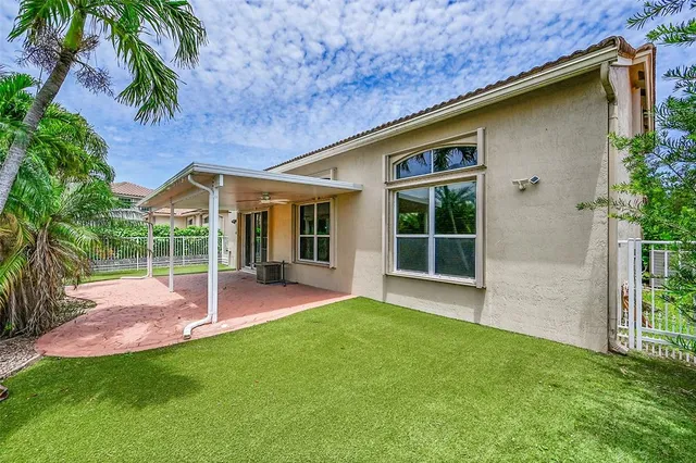 a view of a backyard with table and chairs and potted plants