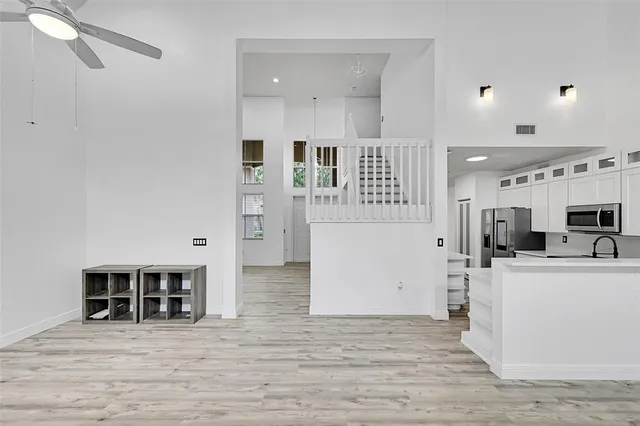a view of a kitchen with furniture and wooden floor