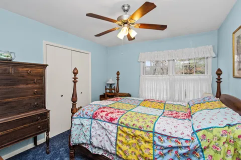 a bedroom that has a bed and a table in it