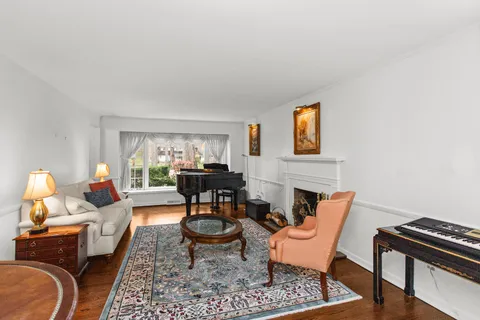a living room with furniture a rug and a window