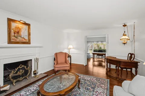 a living room with furniture a rug and a fireplace