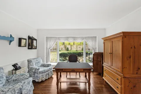a dining room with furniture and wooden floor