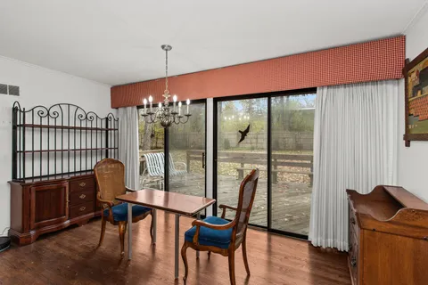 a dining room with furniture and wooden floor