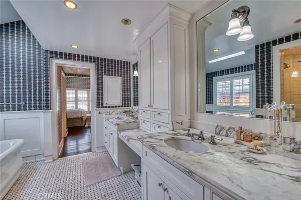 a bathroom with a double vanity sink and a mirror
