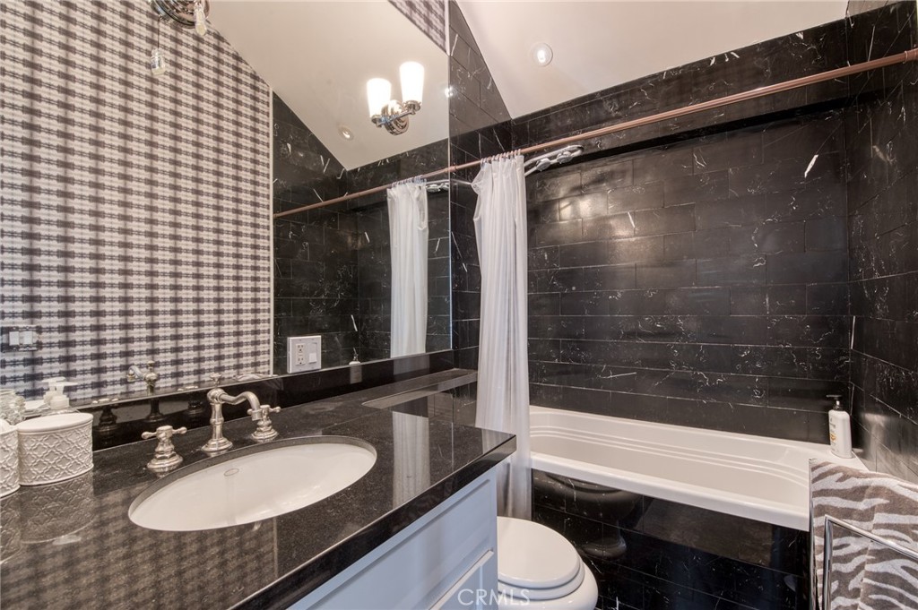 325 Poppy Avenue Corona del Mar, CA 92625 - Photo 15 of 22 a bathroom with a sink a toilet a mirror and shower