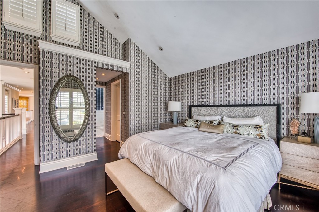 325 Poppy Avenue Corona del Mar, CA 92625 - Photo 17 of 22 a bedroom with a bed a mirror with dresser and mirror