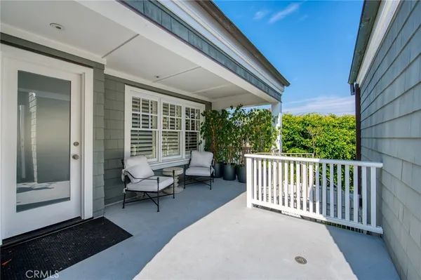 a balcony with furniture and wooden floor