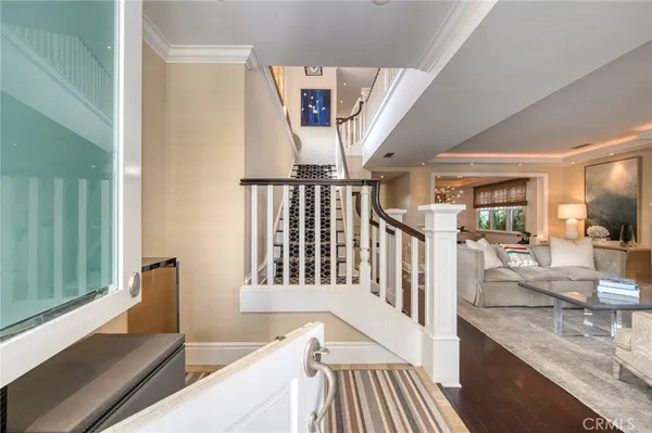 a view of a hallway with wooden floor and staircase