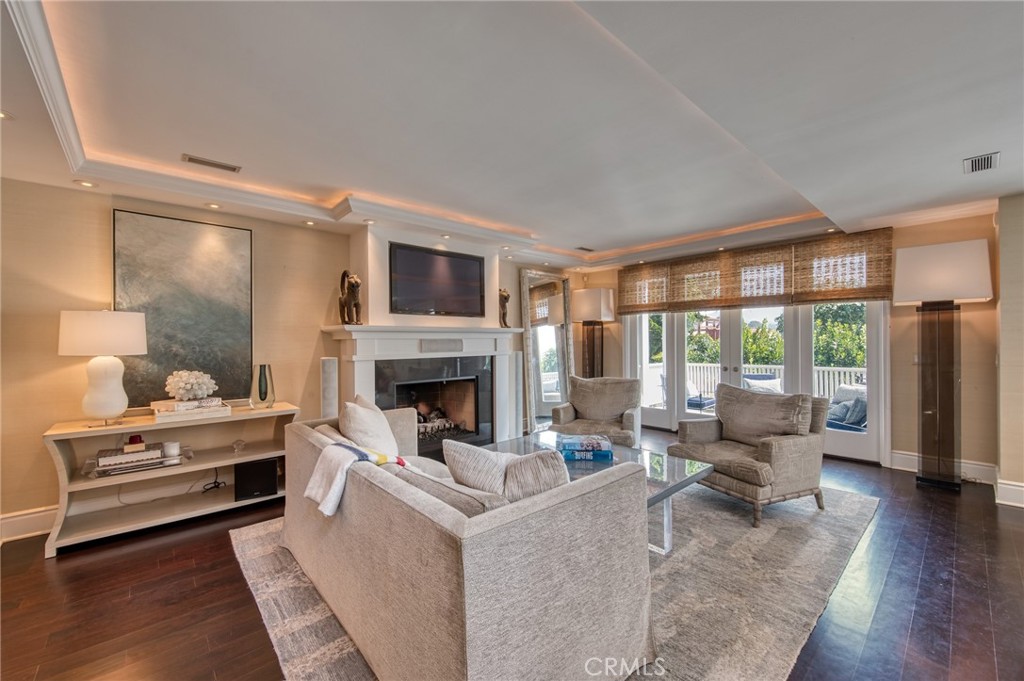 325 Poppy Avenue Corona del Mar, CA 92625 - Photo 4 of 22 a living room with furniture a fireplace and a floor to ceiling window