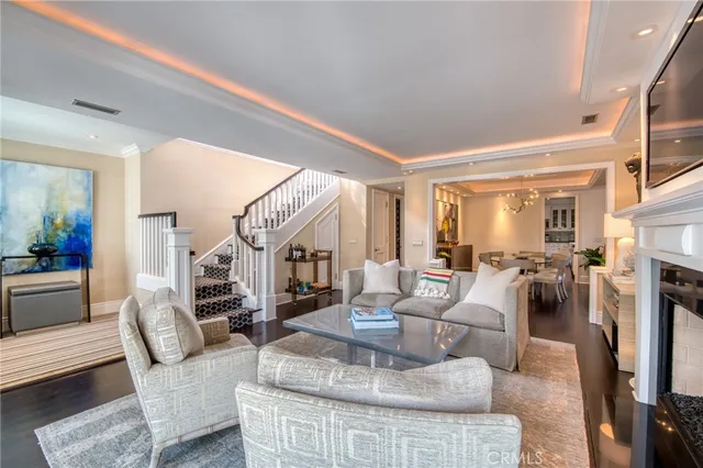 a living room with fireplace furniture and a rug