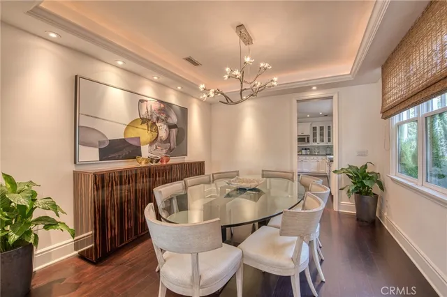 a dining room with furniture potted plants and wooden floor