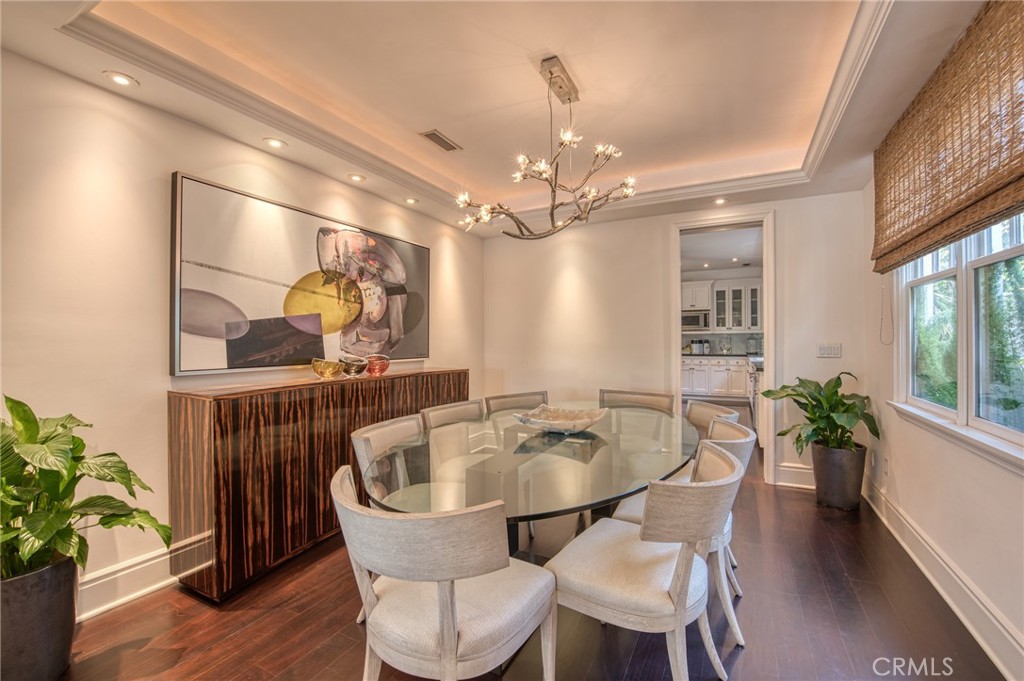 325 Poppy Avenue Corona del Mar, CA 92625 - Photo 7 of 22 a dining room with furniture potted plants and wooden floor