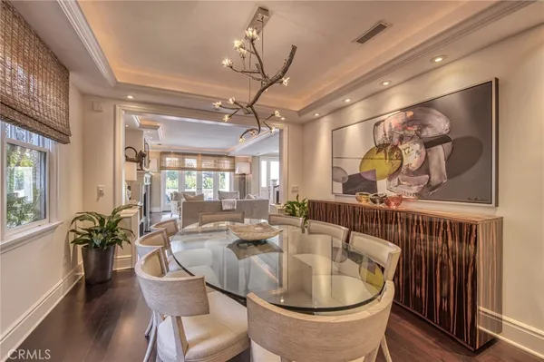a dining room with furniture and wooden floor