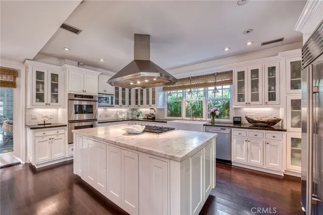 a kitchen with stainless steel appliances granite countertop a stove and a sink