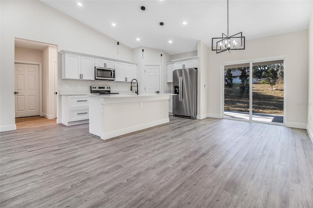 406 Ruby Avenue Deland, FL 32724 - Photo 4 of 23 a large white kitchen with stainless steel appliances