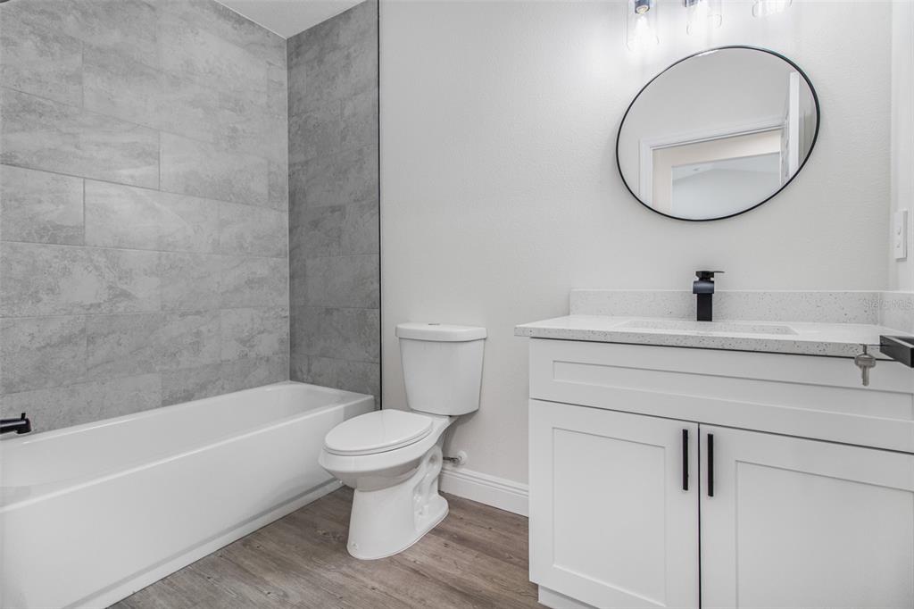 406 Ruby Avenue Deland, FL 32724 - Photo 6 of 23 a bathroom with a toilet a sink and a bathtub