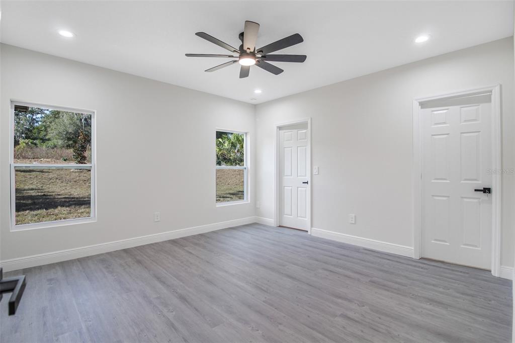 406 Ruby Avenue Deland, FL 32724 - Photo 9 of 23 a view of an empty room with wooden floor and a window
